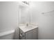 A half bathroom features a grey vanity and toilet with silver hardware at 5573 La Perla Ct, Las Vegas, NV 89122