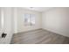 Bedroom with plank flooring and a sun-filled window at 5573 La Perla Ct, Las Vegas, NV 89122