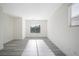 Bright bedroom features neutral paint, modern gray flooring and ample natural light from a window at 5573 La Perla Ct, Las Vegas, NV 89122