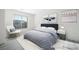 Serene, virtually staged bedroom with plush bedding, modern decor, and ample natural light at 5573 La Perla Ct, Las Vegas, NV 89122