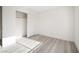This bright bedroom features wood-look flooring and a closet with sliding doors at 5573 La Perla Ct, Las Vegas, NV 89122