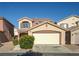Inviting two-story home featuring a two-car garage, desert landscaping, and a cozy front entryway at 5573 La Perla Ct, Las Vegas, NV 89122