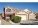 Charming two-story home featuring a two-car garage, desert landscaping, and a cozy front entryway at 5573 La Perla Ct, Las Vegas, NV 89122