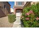 Charming townhome entrance with walkway and lovely greenery with bright pink flowers at 5573 La Perla Ct, Las Vegas, NV 89122