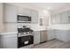 Modern kitchen featuring stainless steel appliances, gas range and light gray cabinetry at 5573 La Perla Ct, Las Vegas, NV 89122