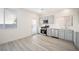 This is a kitchen with stainless steel appliances and gray cabinets at 5573 La Perla Ct, Las Vegas, NV 89122
