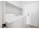 This functional laundry room features a modern, matching washer and dryer at 5573 La Perla Ct, Las Vegas, NV 89122
