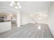 Open-concept layout with light gray flooring connecting the living room and kitchen at 5573 La Perla Ct, Las Vegas, NV 89122