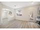 Bright living room featuring an arched entryway, light gray flooring, and large windows at 5573 La Perla Ct, Las Vegas, NV 89122