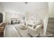 Bright, virtually staged living room with dining area featuring modern furniture, light wood floors, and lots of natural light at 5573 La Perla Ct, Las Vegas, NV 89122