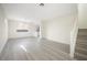 Bright living room with modern light gray wood flooring and light, neutral walls at 5573 La Perla Ct, Las Vegas, NV 89122