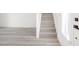 Clean and modern staircase featuring light gray wood flooring and white risers at 5573 La Perla Ct, Las Vegas, NV 89122