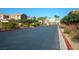 Gated community entrance with well-maintained landscaping, ensuring privacy and security at 5573 La Perla Ct, Las Vegas, NV 89122