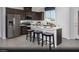 Modern kitchen with stainless steel appliances, dark cabinetry, and a center island with stool seating at 5777 Crenellated St # Lot 56, Las Vegas, NV 89148
