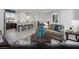 Bright living room featuring a comfortable sofa, stylish rug, and open layout to the kitchen at 5777 Crenellated St # Lot 56, Las Vegas, NV 89148