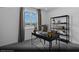 A cozy and bright secondary bedroom featuring a contemporary desk, shelving unit, and large window at 5777 Crenellated St # Lot 56, Las Vegas, NV 89148
