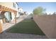 Backyard with a stone paver patio, pergola, and artificial turf, providing a relaxing outdoor area at 5941 Galway Bay St, North Las Vegas, NV 89081