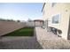 Backyard with stone paver patio, pergola, and artificial turf, ideal for relaxing and entertaining at 5941 Galway Bay St, North Las Vegas, NV 89081