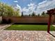 Private backyard featuring artificial turf and a brick patio, perfect for outdoor entertaining or relaxing at 5941 Galway Bay St, North Las Vegas, NV 89081