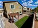 This backyard features a pergola, small grass area, and desert landscaping at 5941 Galway Bay St, North Las Vegas, NV 89081