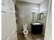 This bathroom features a toilet, sink with vanity, and a built in storage unit at 5941 Galway Bay St, North Las Vegas, NV 89081