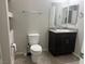 Well-lit bathroom featuring a modern vanity with granite countertop and updated fixtures at 5941 Galway Bay St, North Las Vegas, NV 89081