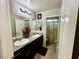 Bathroom featuring dual sinks, tile flooring, and granite countertops at 5941 Galway Bay St, North Las Vegas, NV 89081