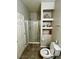 This bathroom features a toilet, shower, and built-in shelving with decor at 5941 Galway Bay St, North Las Vegas, NV 89081