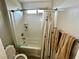 Bright bathroom showcasing a clean, well-maintained shower-tub combination with white tile surround at 5941 Galway Bay St, North Las Vegas, NV 89081