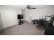 Bedroom with carpet, ceiling fan, closet doors, and dark-colored desk at 5941 Galway Bay St, North Las Vegas, NV 89081