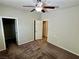 Neutral bedroom with ceiling fan and an open closet shows possibilities for relaxing private time at 5941 Galway Bay St, North Las Vegas, NV 89081