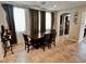 Open dining room featuring a dark wood table, tile floors, with natural light and neutral paint at 5941 Galway Bay St, North Las Vegas, NV 89081