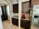 Kitchenette area adjacent to dining room featuring dark cabinets and granite countertops at 5941 Galway Bay St, North Las Vegas, NV 89081