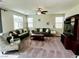 Comfortable living room with plush carpeting, ceiling fan, and abundant natural light, perfect for relaxing or entertaining guests at 5941 Galway Bay St, North Las Vegas, NV 89081