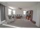 Spacious living room with bright windows, carpet flooring, and comfortable furnishings at 5941 Galway Bay St, North Las Vegas, NV 89081