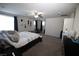 Spacious main bedroom with carpet, ceiling fan, and dark curtains for privacy at 5941 Galway Bay St, North Las Vegas, NV 89081