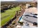 Aerial view of a modern home featuring a rooftop deck with pool overlooking the community golf course at 641 Majestic Rim Dr, Henderson, NV 89012
