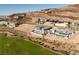 An aerial view showcases modern hillside homes with private pools overlooking the golf course community at 641 Majestic Rim Dr, Henderson, NV 89012