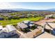 A high-angle aerial view shows modern home architecture surrounded by a golf course and desert landscape at 641 Majestic Rim Dr, Henderson, NV 89012