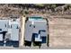 An aerial view of a modern home shows the pool and rooftop design, set in desert landscape at 641 Majestic Rim Dr, Henderson, NV 89012