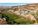 Aerial view of a hillside community overlooking golf course with luxury modern homes and green landscape at 641 Majestic Rim Dr, Henderson, NV 89012