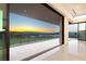 Expansive balcony with glass railings showcasing panoramic views of the city and mountains at sunset at 641 Majestic Rim Dr, Henderson, NV 89012