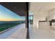 Balcony view into the living area with sleek kitchen and an expansive view of the city skyline at 641 Majestic Rim Dr, Henderson, NV 89012
