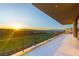 Long, tiled balcony at sunset with views of the golf course, desert and mountains at 641 Majestic Rim Dr, Henderson, NV 89012