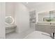 Elegant bathroom featuring an illuminated mirror, bathtub and vanity area at 641 Majestic Rim Dr, Henderson, NV 89012