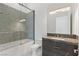 Modern bathroom featuring a tub and shower with textured tile and sleek vanity with granite countertop at 641 Majestic Rim Dr, Henderson, NV 89012
