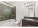 Modern bathroom features tiled shower, marble counter and contemporary lighting at 641 Majestic Rim Dr, Henderson, NV 89012