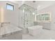 Luxurious bathroom with a soaking tub, glass shower, and dual vanities at 641 Majestic Rim Dr, Henderson, NV 89012
