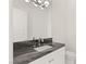 Modern bathroom featuring granite countertop, a sleek faucet, and modern lighting at 641 Majestic Rim Dr, Henderson, NV 89012