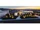 A luxury home with an illuminated walkway surrounded by manicured landscaping at twilight at 641 Majestic Rim Dr, Henderson, NV 89012